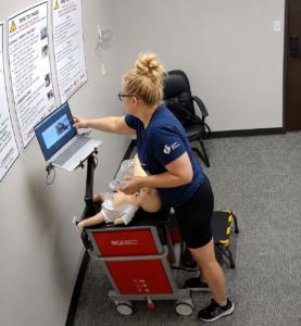 Healthcare professional practicing infant CPR during an American Heart Association BLS, ACLS, or PALS skills session at Citywide CPR.