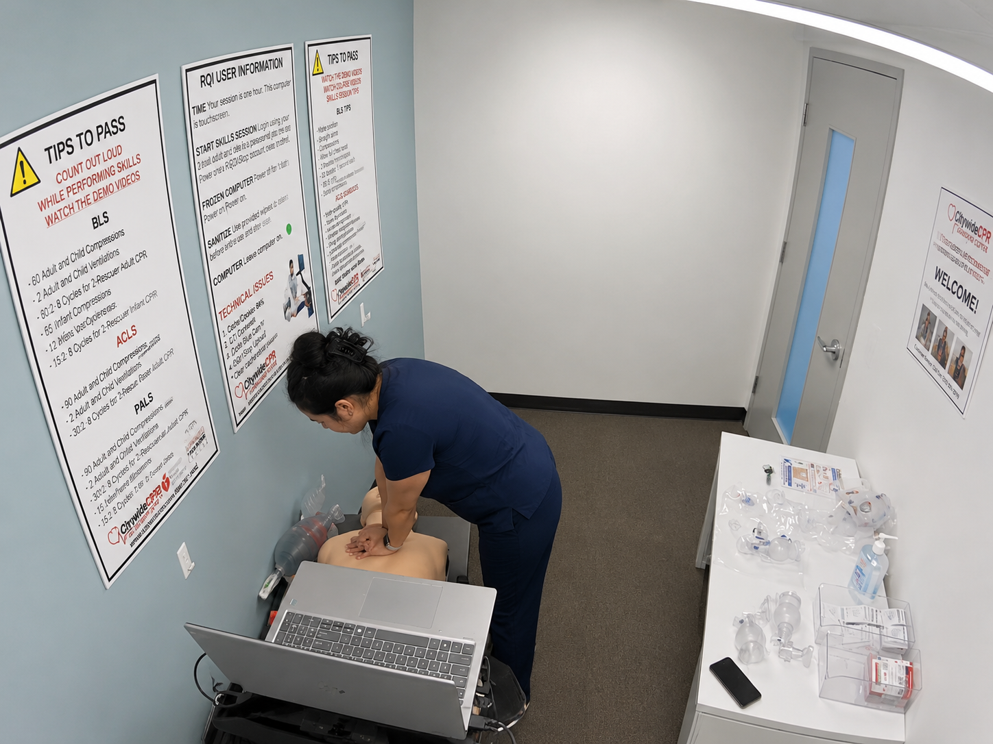 Healthcare student performing CPR on an adult manikin during an American Heart Association BLS skills session.