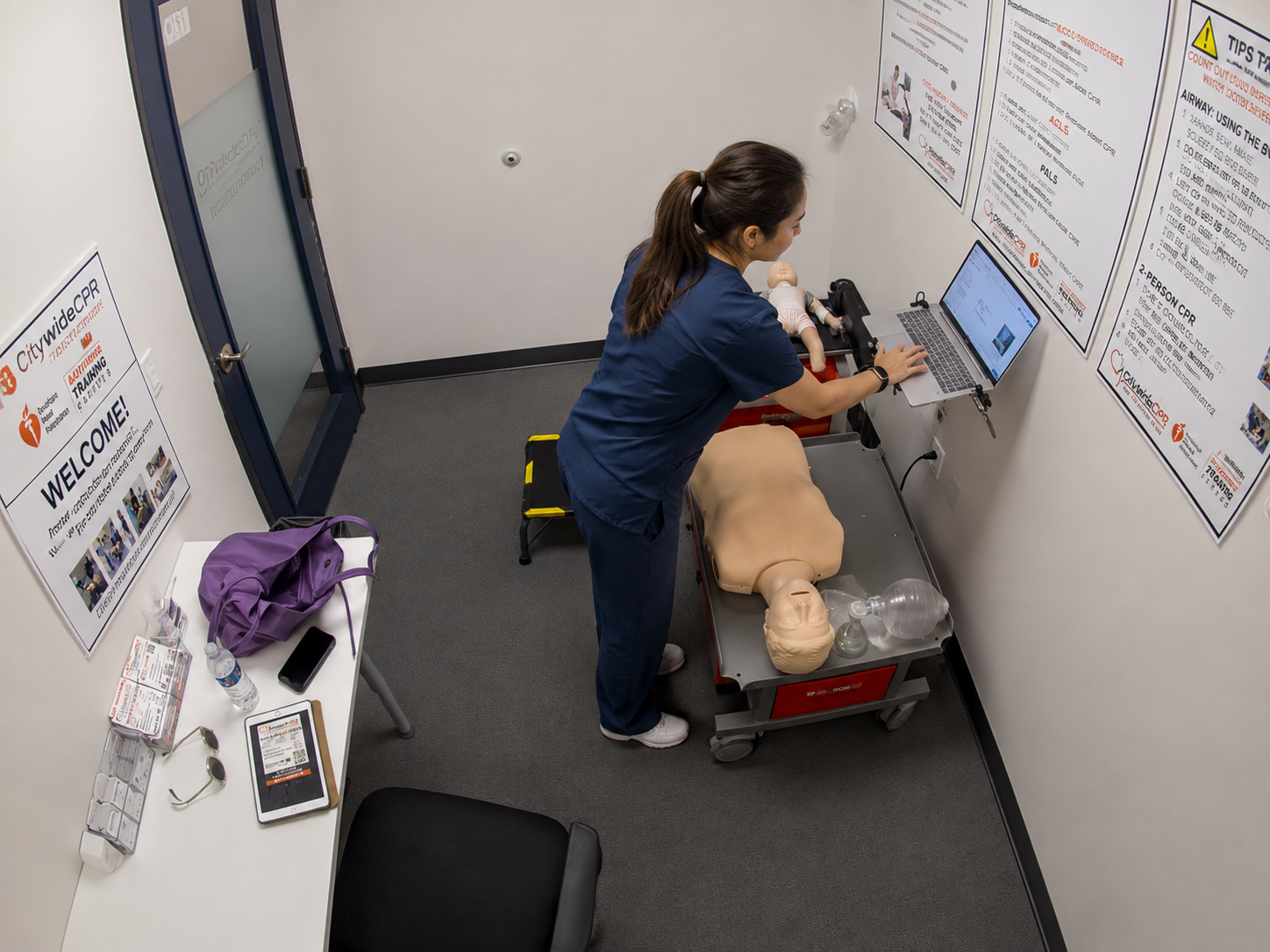 Healthcare professional completing online BLS coursework on a laptop before an American Heart Association hands-on skills session.