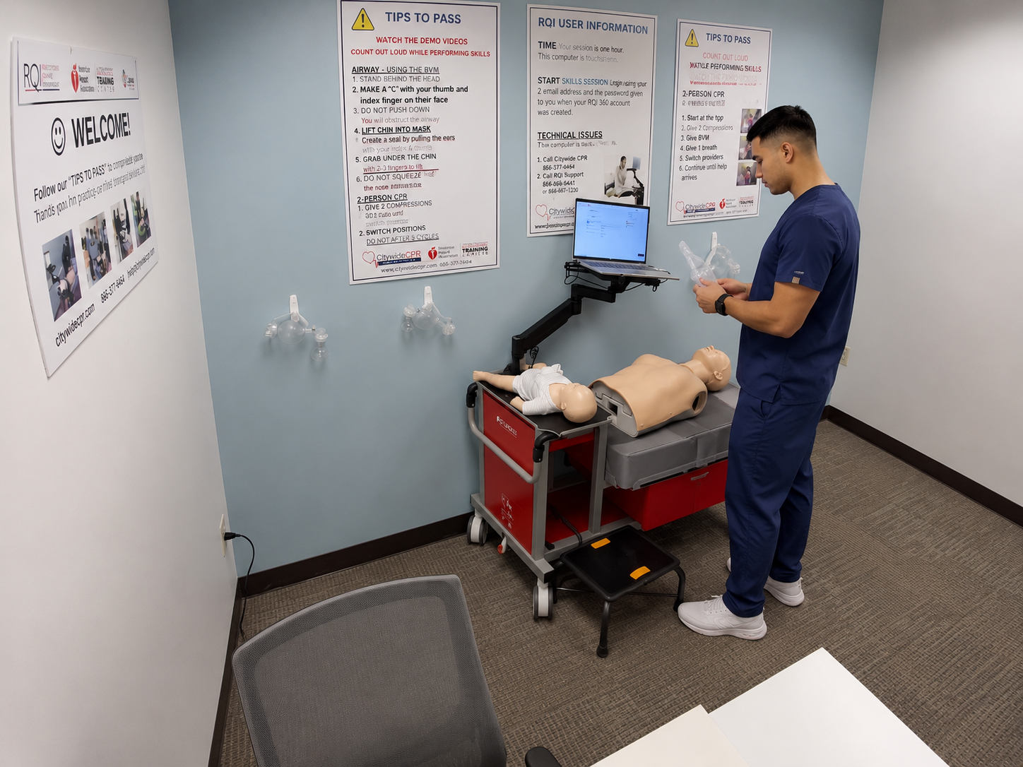Healthcare professional completing an American Heart Association BLS skills session with an adult CPR manikin.