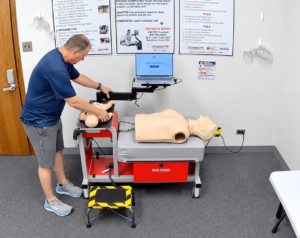 Participant performing adult CPR compressions at a Citywide CPR Verification Station.