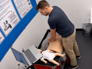 Healthcare student completing American Heart Association BLS skills before clinical rotations at a Citywide CPR Verification Station.