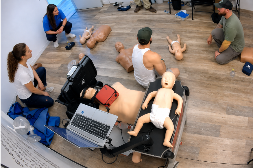 Healthcare employees participating in CPR certification training with professional training equipment.