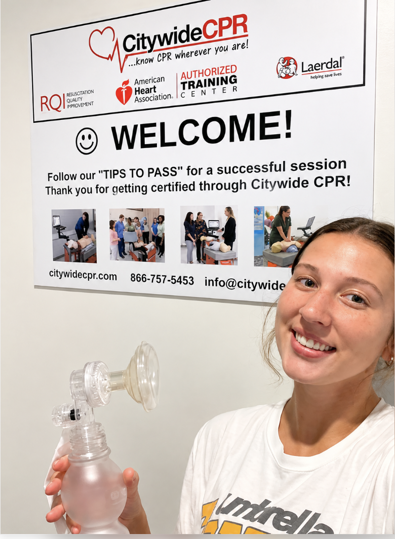 Participant holding CPR ventilation equipment inside a Citywide CPR Self-Guided Skills Session training room.