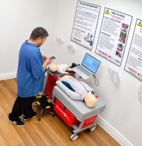 Customer completing an AHA BLS Self-Guided Skills Session at a Citywide CPR Verification Station.