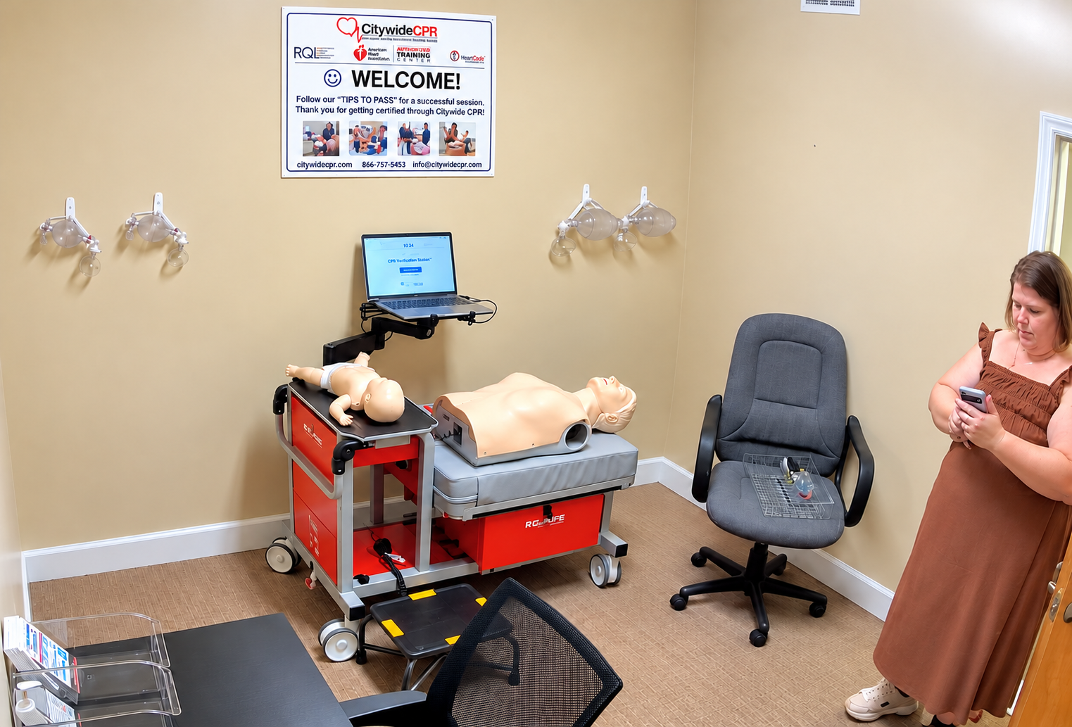 Customer at Citywide CPR's Downtown Tallahassee training room with adult and infant CPR manikins and a Self-Guided CPR Verification Station.